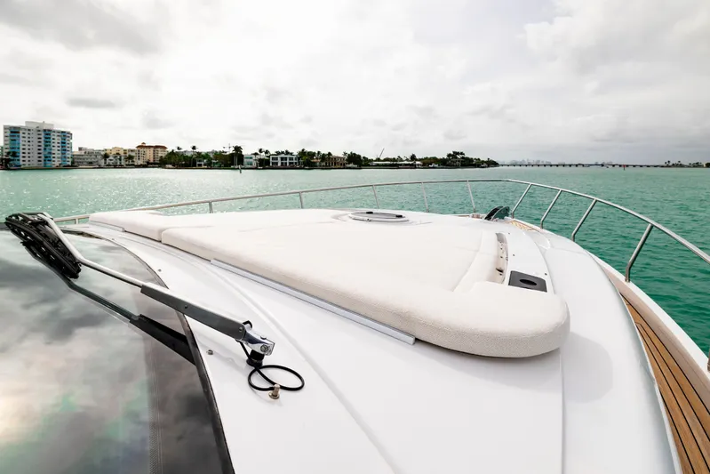 Sea Suite Yacht Photos Pics 2021 Pershing 62 yacht deck with ocean view and coastal skyline.