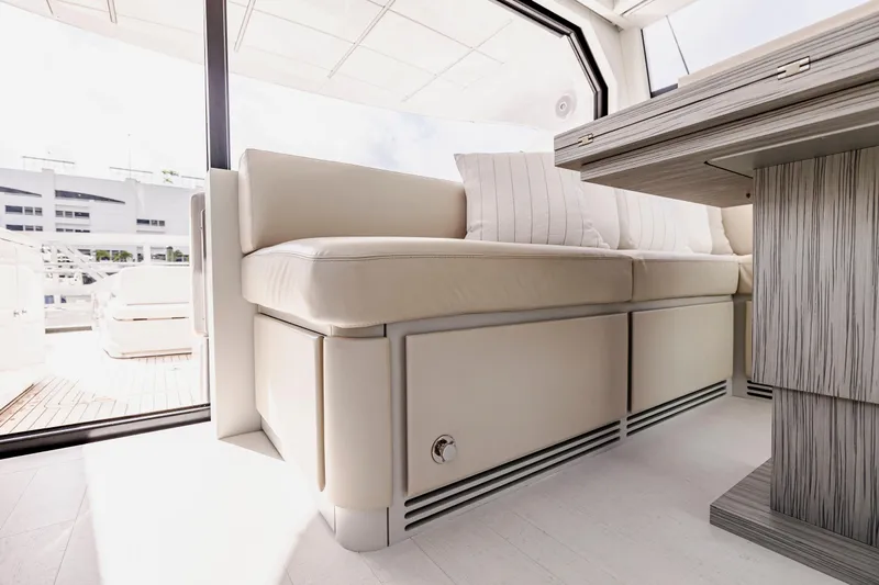 Sea Suite Yacht Photos Pics Luxurious interior of 2021 Pershing 62 yacht with elegant seating and modern design.