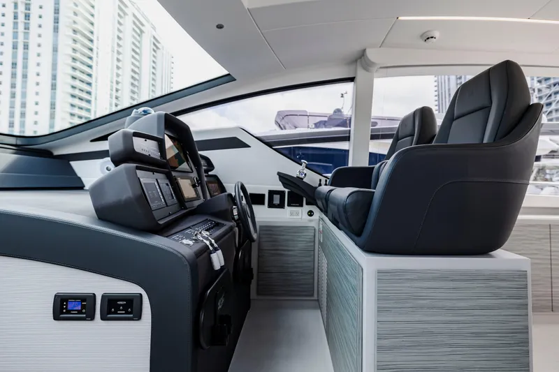 Sea Suite Yacht Photos Pics Interior of 2021 Pershing 62 yacht cockpit with modern controls and luxurious seating.