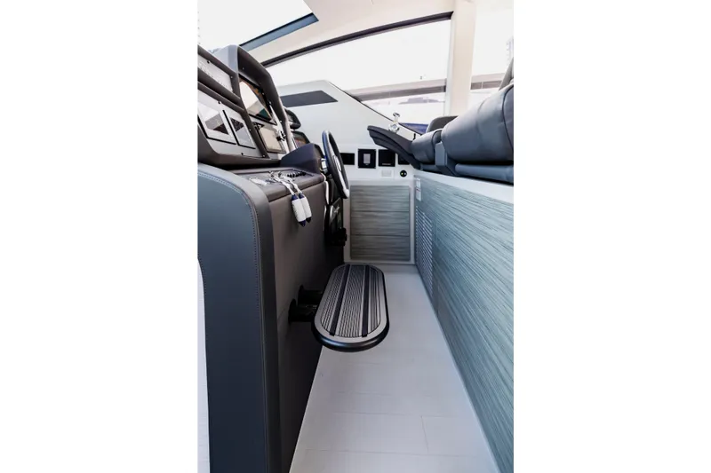 Sea Suite Yacht Photos Pics Interior of 2021 Pershing 62 yacht cockpit with modern controls and seating.