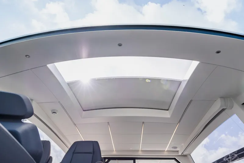 Sea Suite Yacht Photos Pics Sunroof view inside 2021 Pershing 62 yacht, showcasing sleek interior design and natural light.