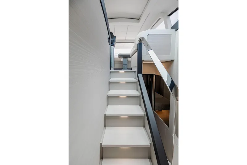 Sea Suite Yacht Photos Pics Staircase inside 2021 Pershing 62 yacht, featuring modern design and ambient lighting.