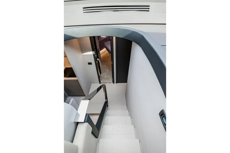 Sea Suite Yacht Photos Pics Interior staircase of 2021 Pershing 62 yacht, featuring modern design and sleek finishes.