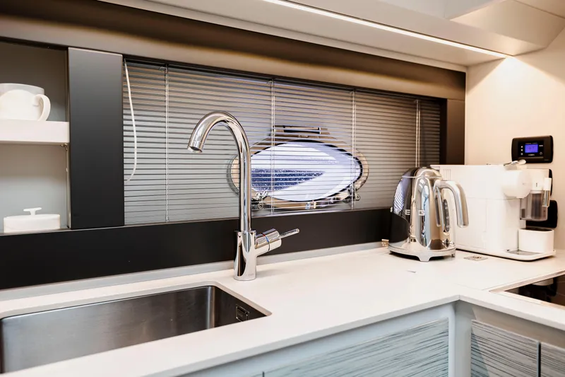 Sea Suite Yacht Photos Pics Modern kitchen interior on 2021 Pershing 62 yacht with sleek appliances and stylish design.