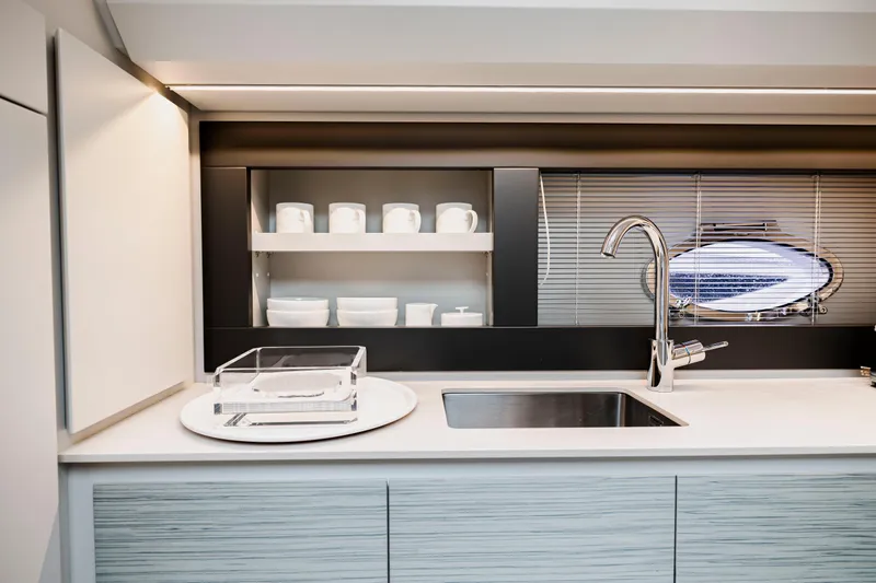 Sea Suite Yacht Photos Pics Modern kitchen interior of 2021 Pershing 62 yacht with sleek design and stainless steel fixtures.