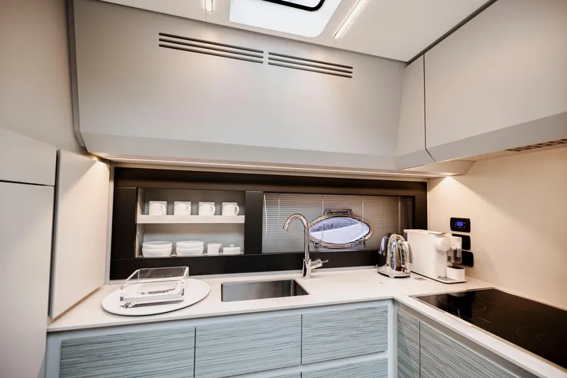 Sea Suite Yacht Photos Pics Modern kitchen interior on 2021 Pershing 62 yacht, featuring sleek design and appliances.