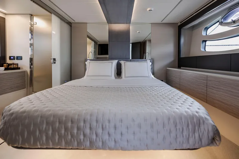 Sea Suite Yacht Photos Pics Luxurious bedroom interior of 2021 Pershing 62 yacht with modern design and elegant bedding.