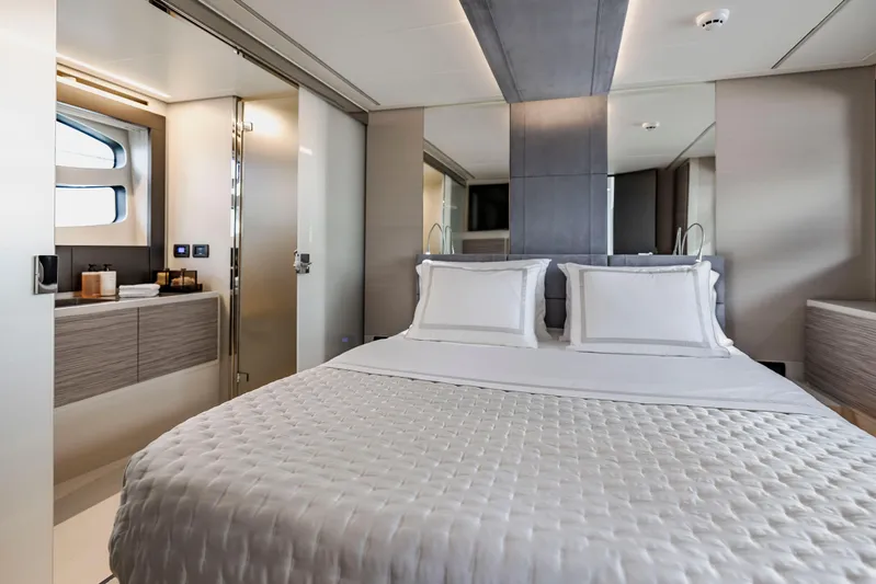 Sea Suite Yacht Photos Pics Luxurious bedroom interior of 2021 Pershing 62 yacht with modern design and elegant bedding.