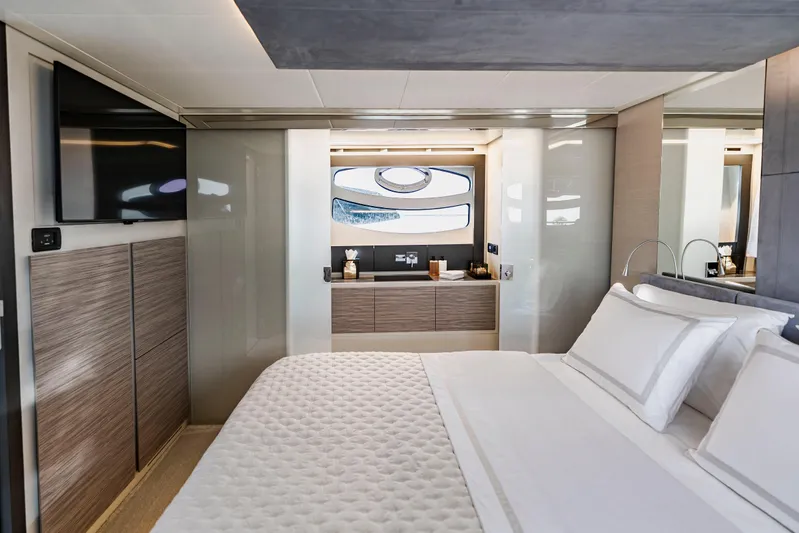 Sea Suite Yacht Photos Pics Luxurious bedroom interior of 2021 Pershing 62 yacht with modern design and elegant furnishings.