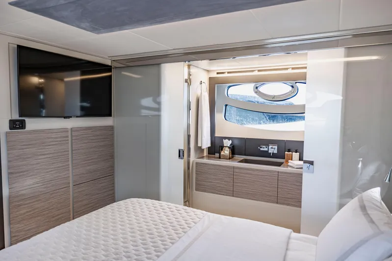 Sea Suite Yacht Photos Pics Luxurious interior of 2021 Pershing 62 yacht featuring modern bedroom and bathroom design.