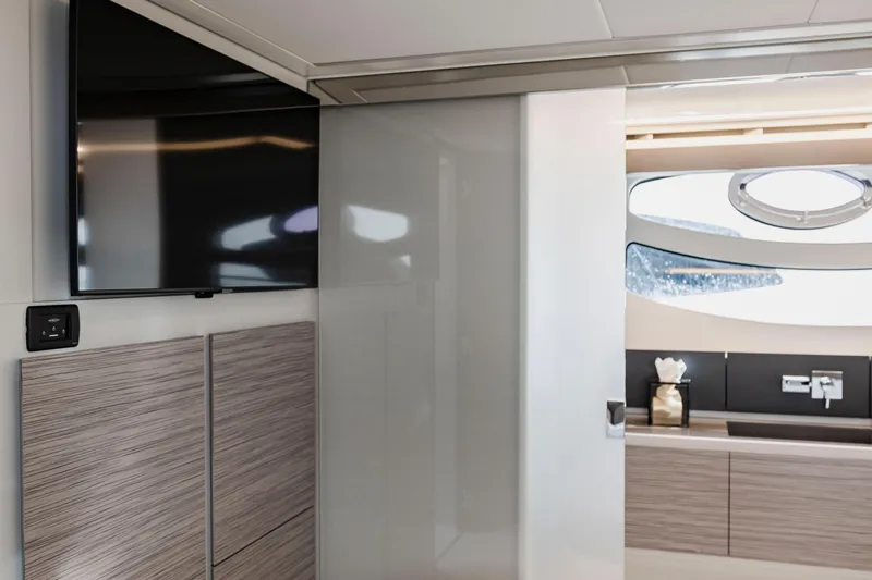 Sea Suite Yacht Photos Pics Interior of 2021 Pershing 62 yacht featuring modern design with TV and sleek cabinetry.