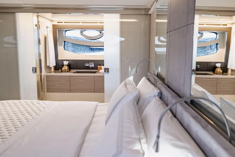 Sea Suite Yacht Photos Pics Luxurious interior of 2021 Pershing 62 yacht featuring elegant bedroom and modern bathroom.