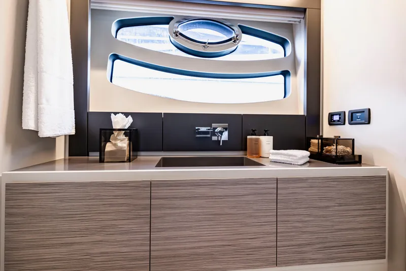 Sea Suite Yacht Photos Pics Luxurious bathroom interior of 2021 Pershing 62 yacht with modern fixtures and window.