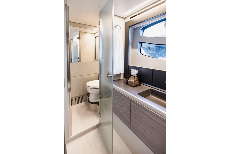 Sea Suite Yacht Photos Pics Luxurious bathroom interior of 2021 Pershing 62 yacht with modern fixtures and window view.