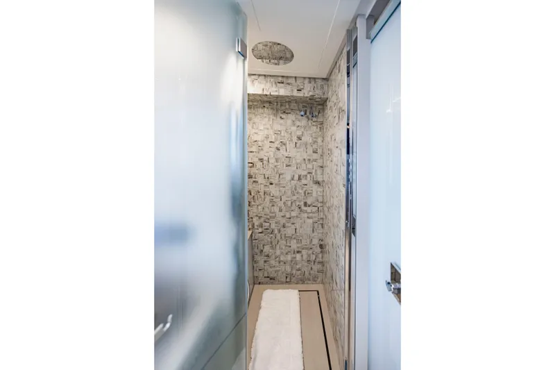 Sea Suite Yacht Photos Pics Modern bathroom interior on 2021 Pershing 62 yacht, featuring sleek design and textured walls.
