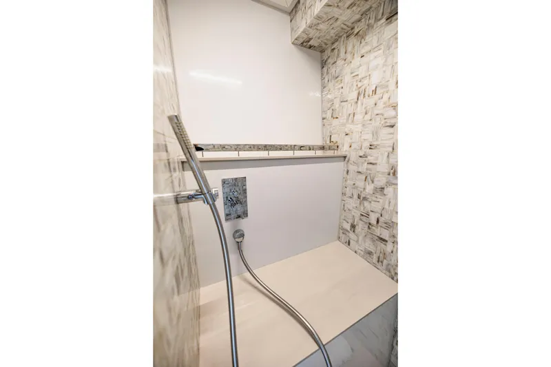 Sea Suite Yacht Photos Pics Luxurious shower area in 2021 Pershing 62 yacht with modern fixtures and elegant tile design.