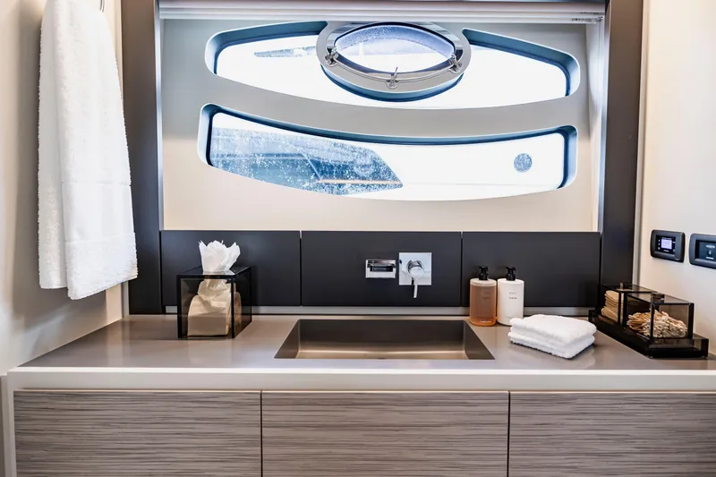 Sea Suite Yacht Photos Pics Luxurious bathroom interior of 2021 Pershing 62 yacht with modern fixtures and window view.