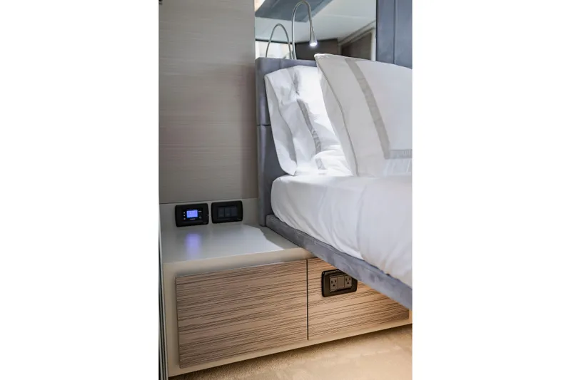 Sea Suite Yacht Photos Pics Luxurious bedroom interior of 2021 Pershing 62 yacht with modern bedside controls.