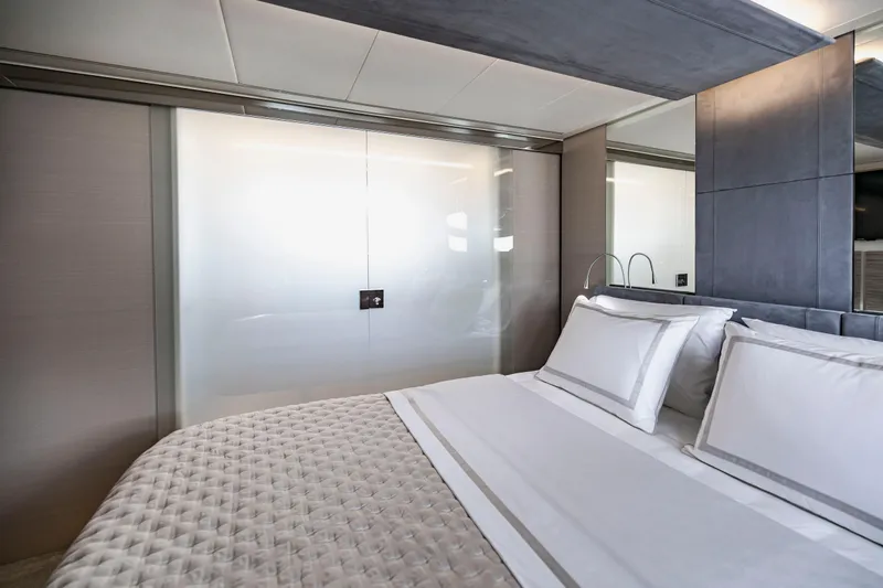 Sea Suite Yacht Photos Pics Luxurious bedroom interior on 2021 Pershing 62 yacht, featuring elegant bedding and modern design.