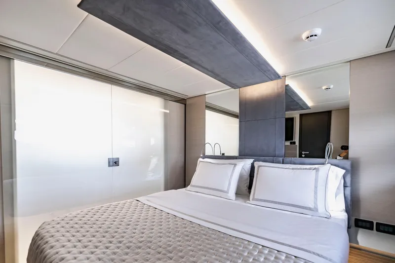 Sea Suite Yacht Photos Pics Luxurious bedroom interior on 2021 Pershing 62 yacht, featuring modern design and elegant bedding.