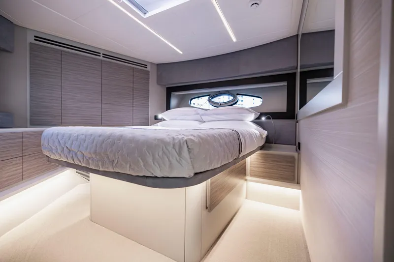 Sea Suite Yacht Photos Pics Luxurious bedroom interior of 2021 Pershing 62 yacht with modern design and ambient lighting.