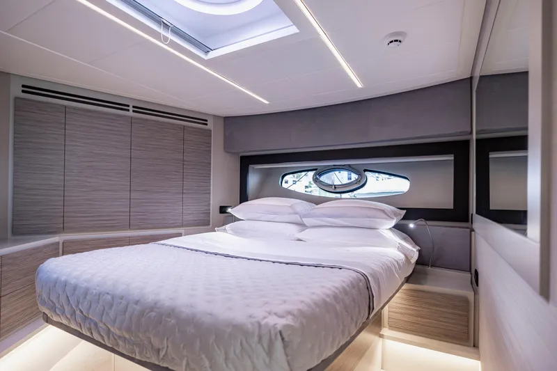Sea Suite Yacht Photos Pics Luxurious bedroom interior of 2021 Pershing 62 yacht with modern design and skylight.