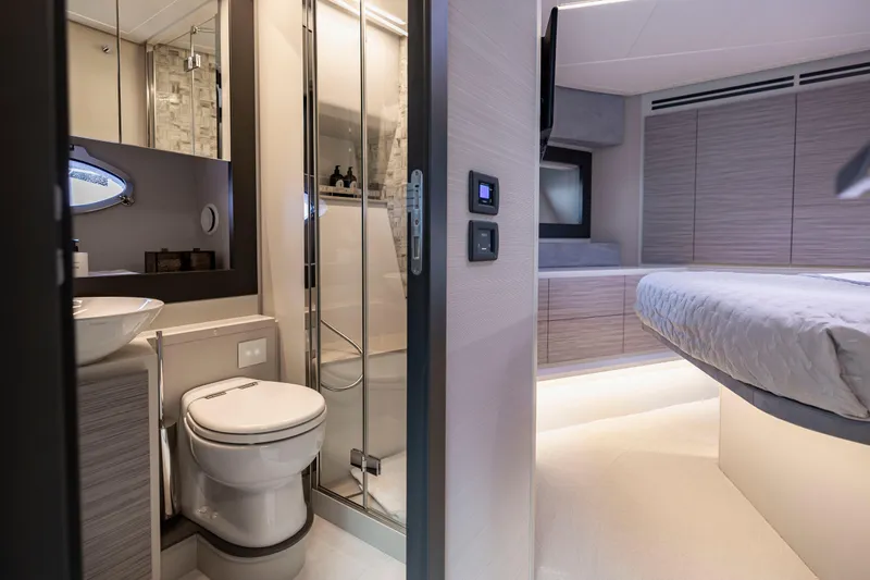 Sea Suite Yacht Photos Pics Luxurious interior of 2021 Pershing 62 yacht featuring modern bathroom and bedroom design.