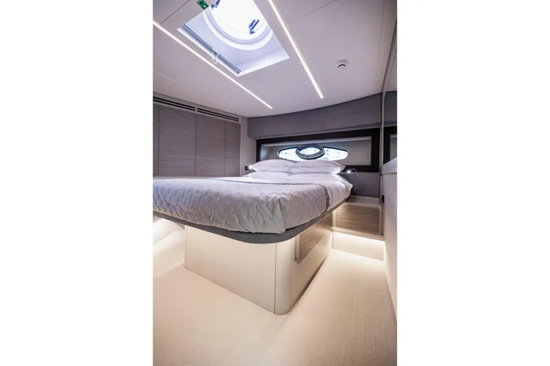 Sea Suite Yacht Photos Pics Luxurious bedroom interior of 2021 Pershing 62 yacht with modern design and skylight.