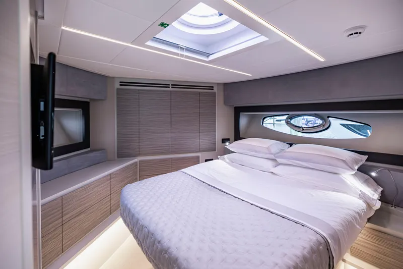 Sea Suite Yacht Photos Pics Luxurious bedroom interior of 2021 Pershing 62 yacht with modern design and skylight.