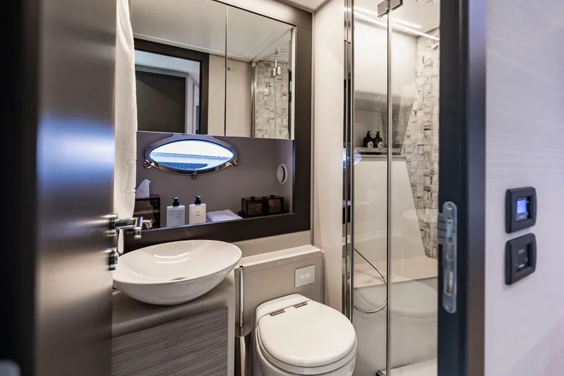 Sea Suite Yacht Photos Pics Luxurious bathroom interior of 2021 Pershing 62 yacht with modern fixtures and elegant design.