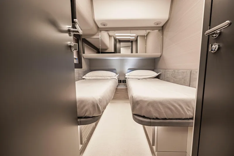 Sea Suite Yacht Photos Pics Luxurious twin cabin interior of 2021 Pershing 62 yacht, featuring modern design and comfort.