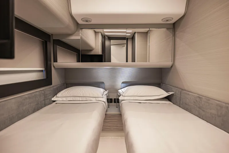 Sea Suite Yacht Photos Pics Luxurious twin cabin interior of 2021 Pershing 62 yacht, featuring modern design and comfort.