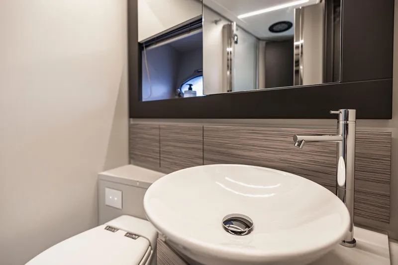 Sea Suite Yacht Photos Pics Luxurious bathroom interior of 2021 Pershing 62 yacht with modern sink and fixtures.