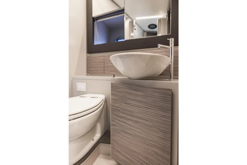 Sea Suite Yacht Photos Pics Modern bathroom interior on 2021 Pershing 62 yacht, featuring sleek sink and toilet design.