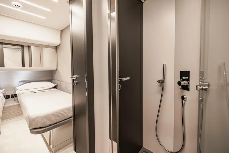 Sea Suite Yacht Photos Pics Luxurious interior of 2021 Pershing 62 yacht featuring bedroom and modern bathroom.