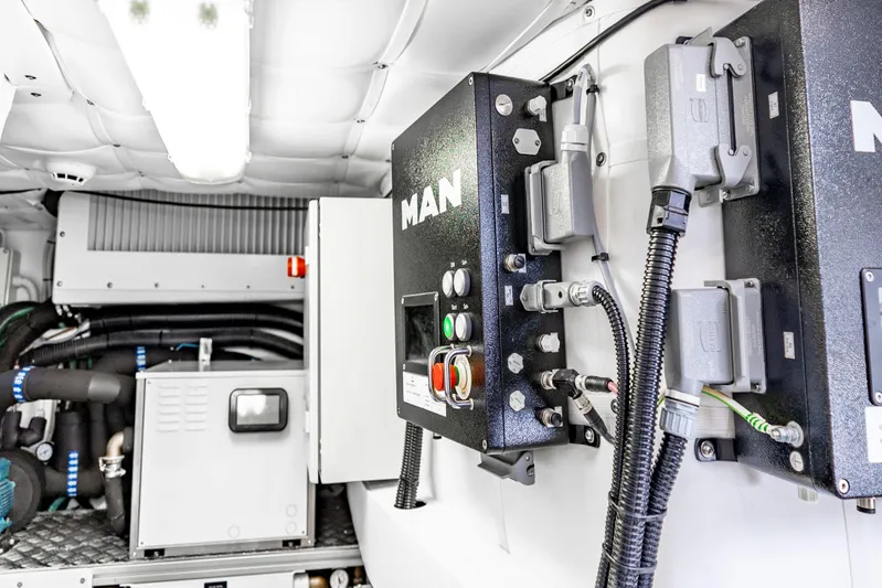 Sea Suite Yacht Photos Pics Engine room of 2021 Pershing 62 yacht, featuring MAN control panels and equipment.