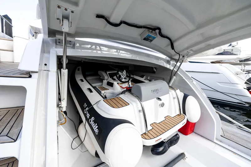 Sea Suite Yacht Photos Pics 2021 Pershing 62 yacht with Turbojet tender in storage compartment.