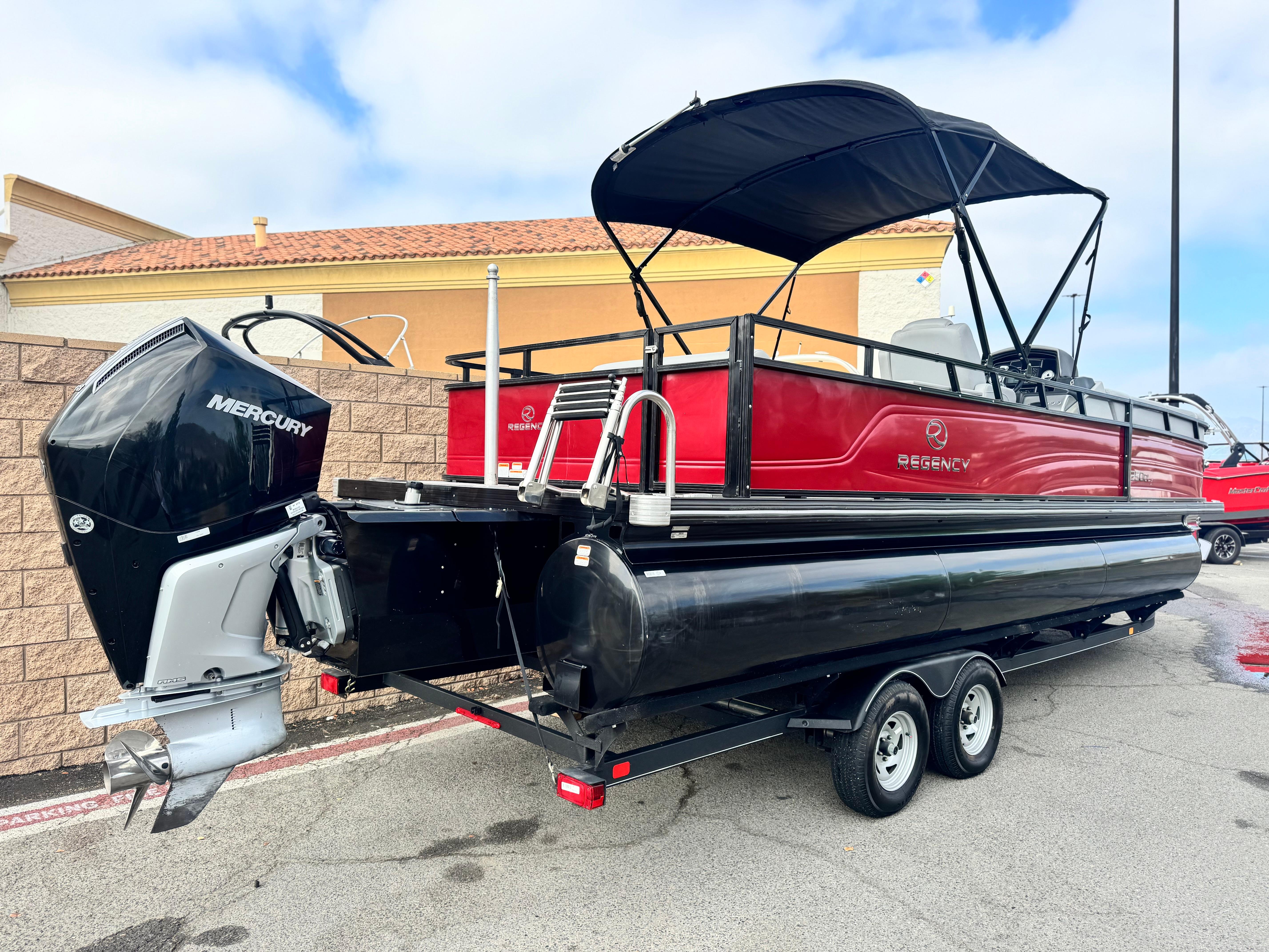 2023 Regency 250 DL3 pontoon boat with Mercury outboard motor on trailer.