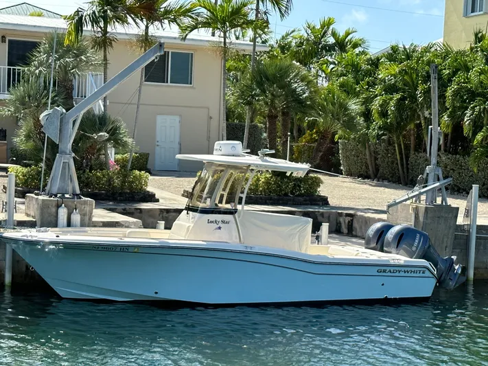  Yacht Photos Pics 2022 Grady-White Fisherman 257 boat docked near tropical foliage.