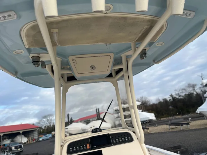  Yacht Photos Pics 2022 Grady-White Fisherman 257 boat console and T-top, parked outdoors.