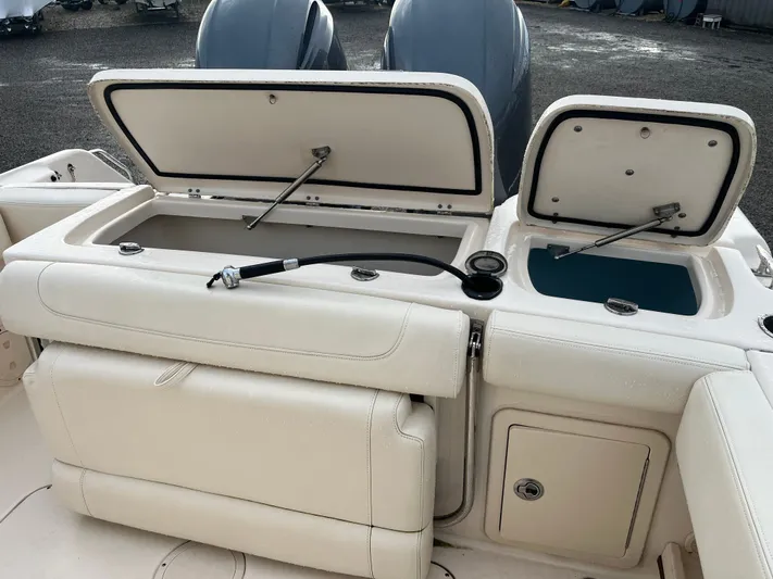  Yacht Photos Pics 2022 Grady-White Fisherman 257 boat with open storage compartments and dual engines.