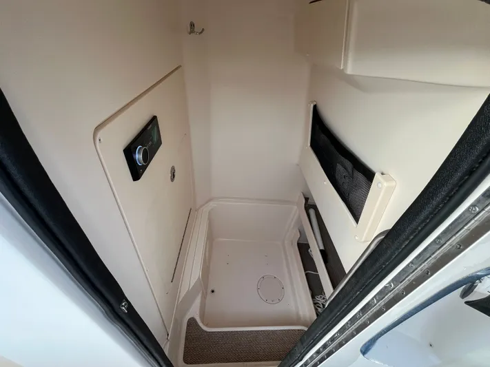  Yacht Photos Pics 2022 Grady-White Fisherman 257 interior cabin with storage and control panel.