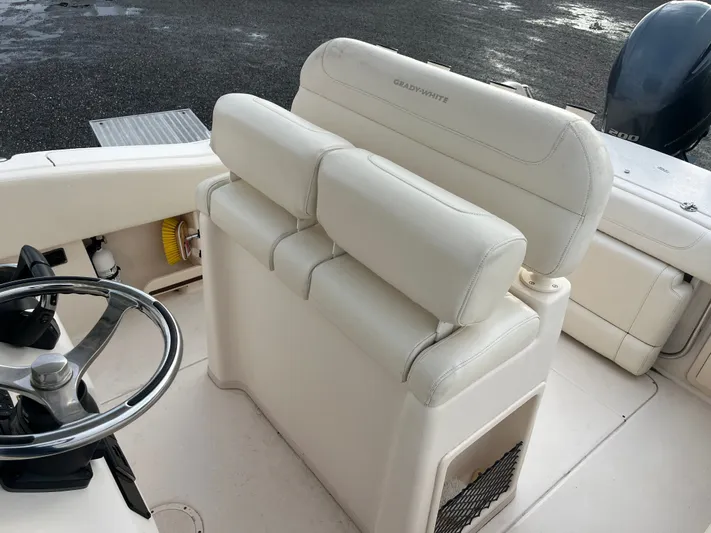  Yacht Photos Pics 2022 Grady-White Fisherman 257 boat interior with steering wheel and cushioned seating.