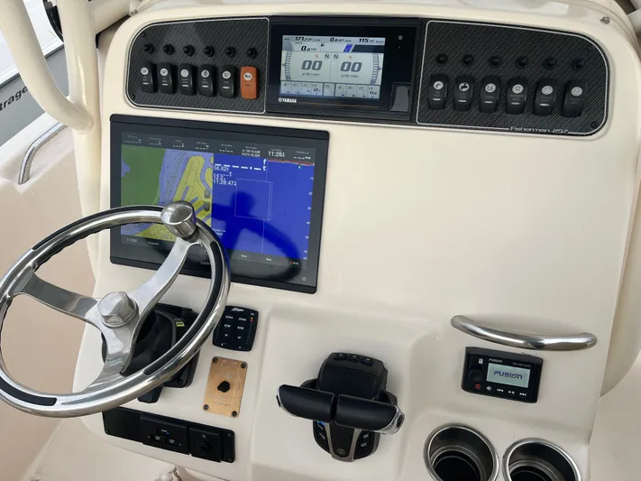  Yacht Photos Pics 2022 Grady-White Fisherman 257 dashboard with steering wheel, navigation, and control panel.