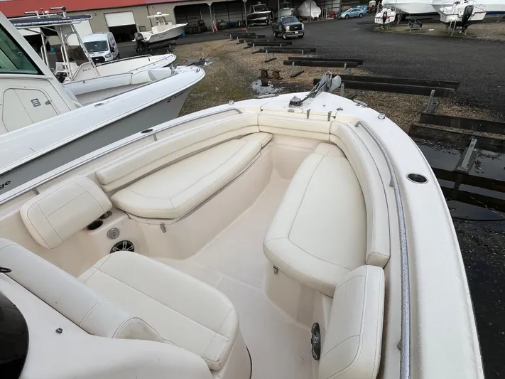  Yacht Photos Pics 2022 Grady-White Fisherman 257 boat with spacious seating in a marina setting.