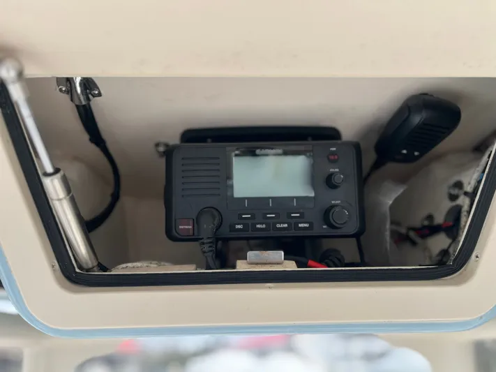  Yacht Photos Pics 2022 Grady-White Fisherman 257 boat radio system in storage compartment.