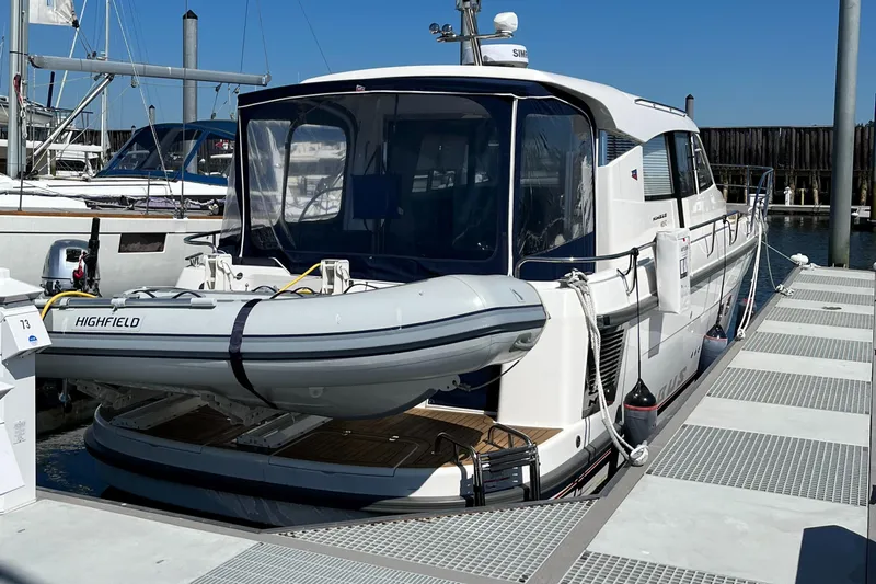  Yacht Photos Pics 2021 Nimbus 405 Coupé #88 yacht docked with inflatable boat on stern.