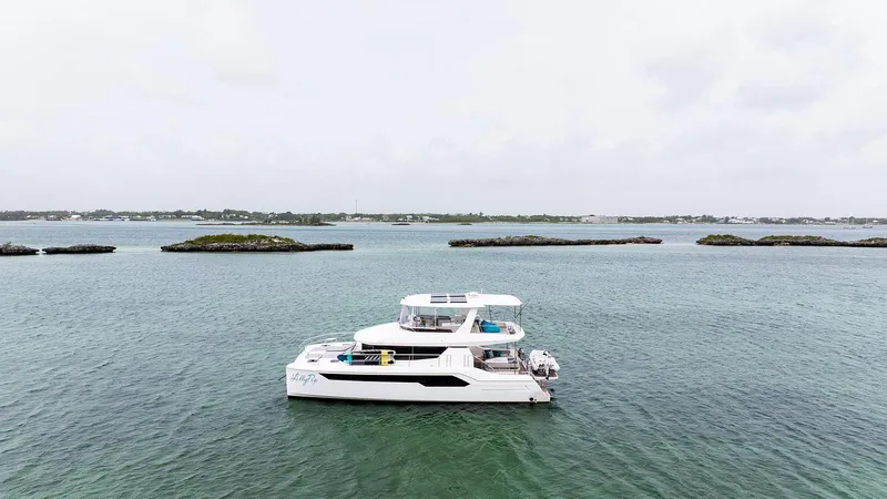 Lollypop Yacht Photos Pics 2022 Leopard 53 Powercat yacht on calm waters with distant islands.