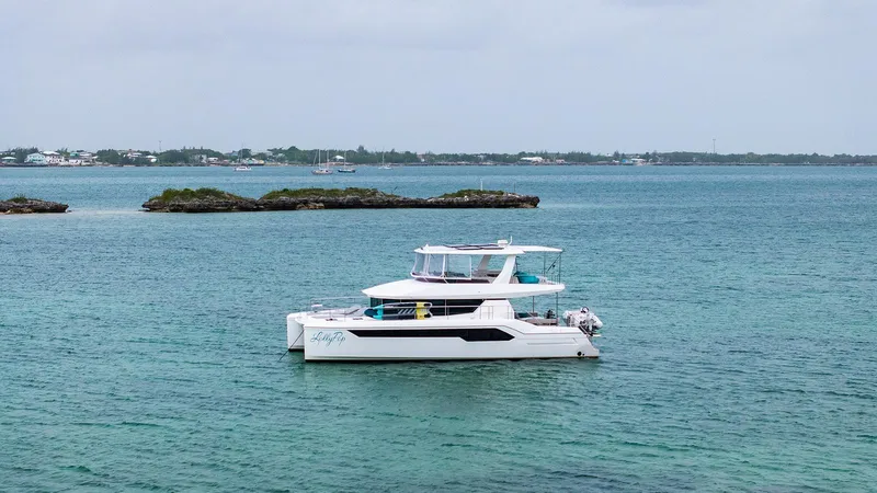 Lollypop Yacht Photos Pics 2022 Leopard 53 Powercat yacht on tranquil blue waters near small islands.