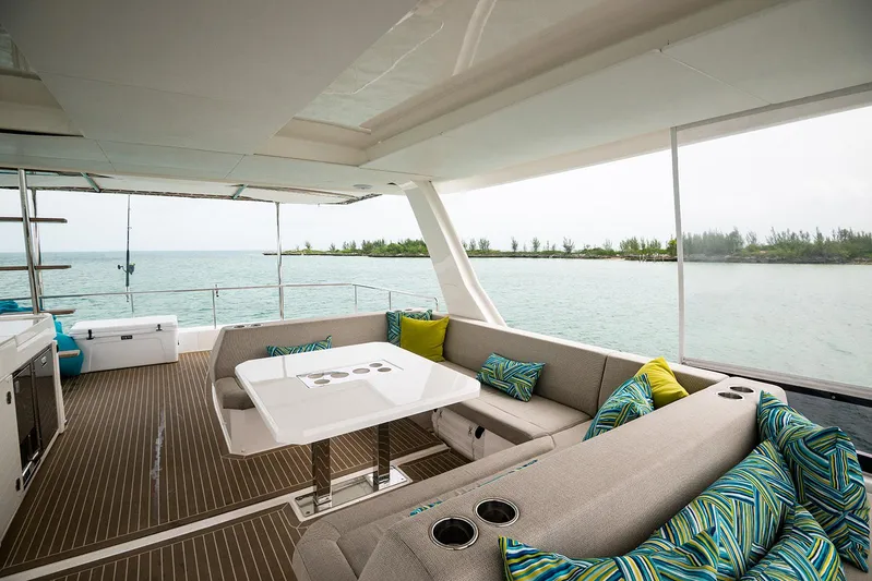 Lollypop Yacht Photos Pics Luxurious 2022 Leopard 53 Powercat yacht interior with ocean view and stylish seating area.